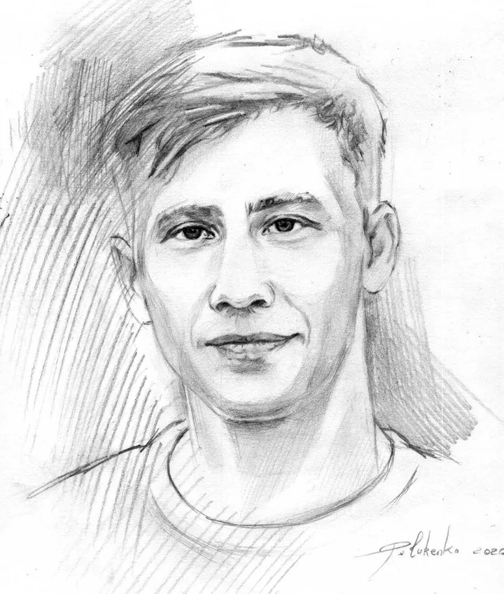 Pencil portrait of Paul, smiling, in a crew-neck T-shirt